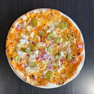 The Buff Chick, a Longshot specialty pizza seen from above: house Buffalo Sauce, Mozzarella & Provolone, Grilled Chicken, Red Onion, Jalapeños, on a blistered brick-oven crust