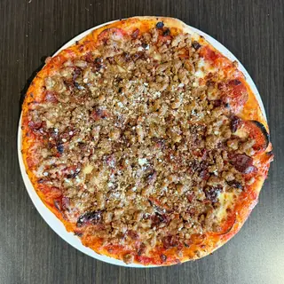The Butcher's Cut, a Longshot specialty pizza seen from above: house Marinara, Mozzarella & Provolone, Pepperoni, Sausage, Beef, Bacon, on a blistered brick-oven crust