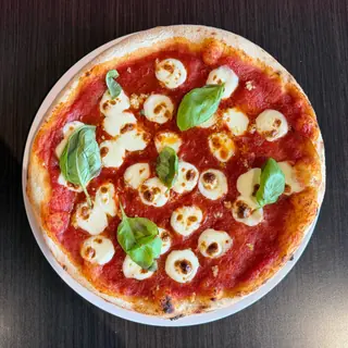 The Classic Marg, a Longshot specialty pizza seen from above: house Marinara, Fresh Mozzarella, Garlic, Olive Oil, Fresh Basil, on a blistered brick-oven crust (vegetarian)