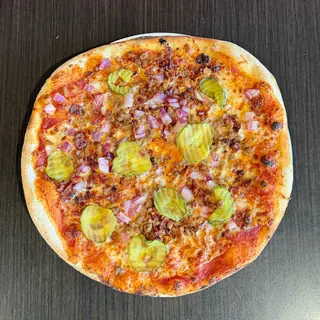 The Flat Burger, a Longshot specialty pizza seen from above: house Marinara, Mozzarella & Provolone, Beef, Bacon, Cheddar, Red Onion, Dill Pickle, on a blistered brick-oven crust