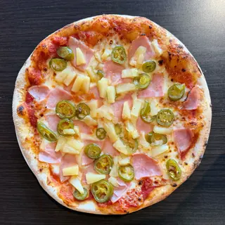 Sweet Heat Hawaiian, a Longshot specialty pizza seen from above: house Marinara, Mozzarella & Provolone, Ham, Pineapple, Jalapeños, Hot Honey Drizzle, on a blistered brick-oven crust
