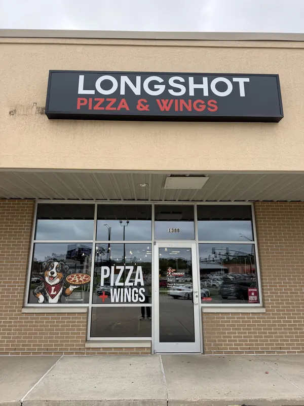 The Longshot Pizza & Wings storefront at 1388 Hamilton Blvd: a black sign reading LONGSHOT in white with PIZZA & WINGS in red, above a glass entrance