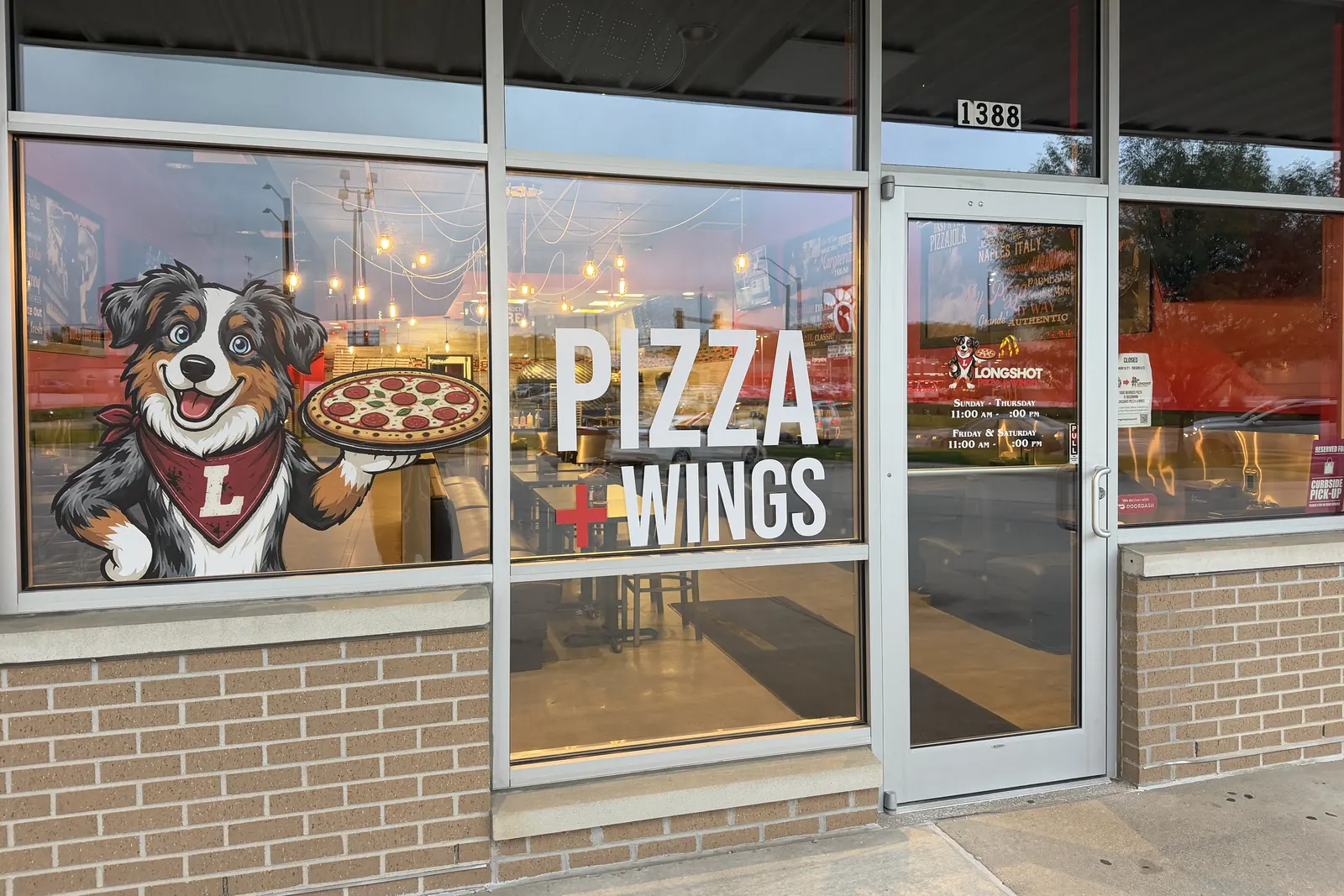 The Longshot Pizza & Wings storefront at 1388 Hamilton Blvd: the entrance and window graphic showing Loki the dog holding a pepperoni pizza beside the words PIZZA + WINGS